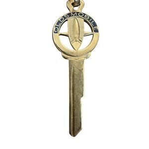 Vintage Oldsmobile Rocket Logo Uncut Key Blank Silver and Black (L) Stamped